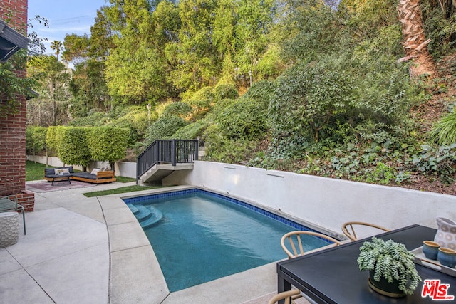 view of pool featuring a patio