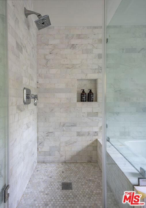 bathroom with separate shower and tub