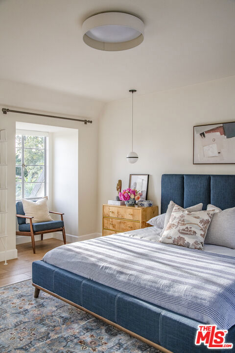 bedroom with wood-type flooring