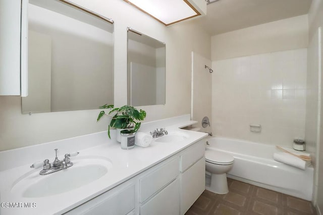 full bathroom with tiled shower / bath combo, vanity, and toilet