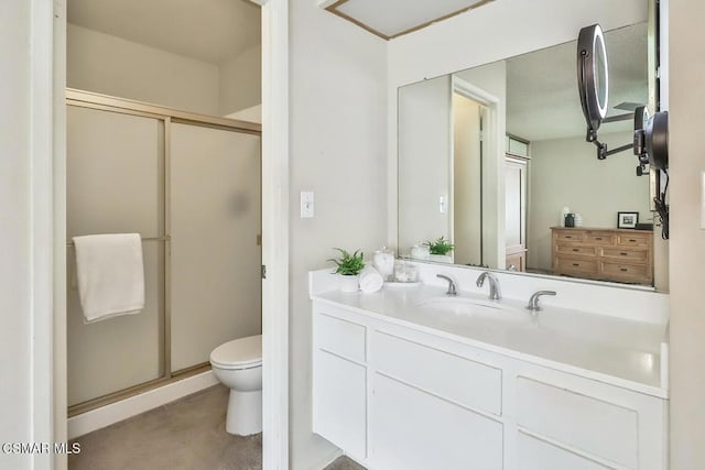 bathroom featuring vanity, toilet, and a shower with door