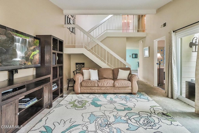 living room featuring a towering ceiling