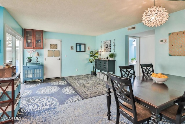 dining room featuring a textured ceiling