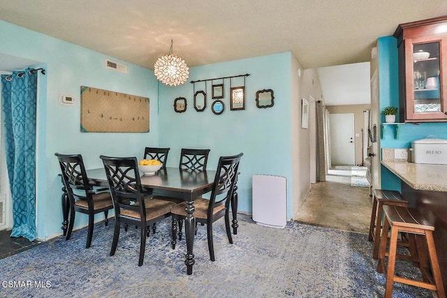 dining area featuring an inviting chandelier