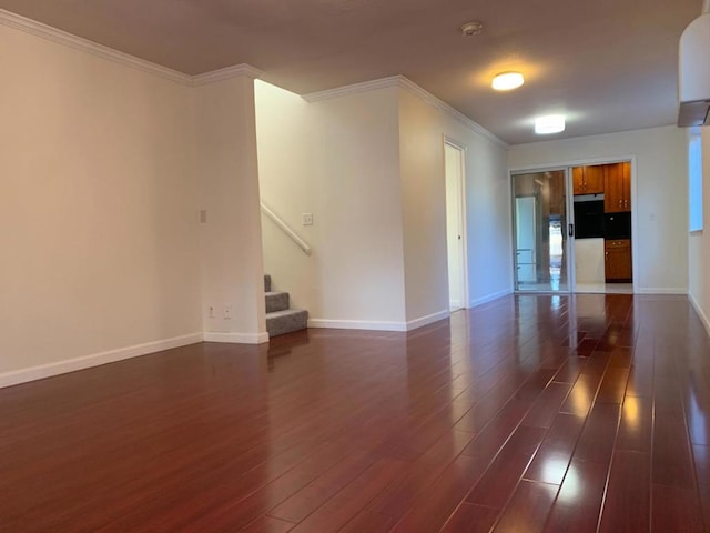 empty room with ornamental molding and dark hardwood / wood-style flooring