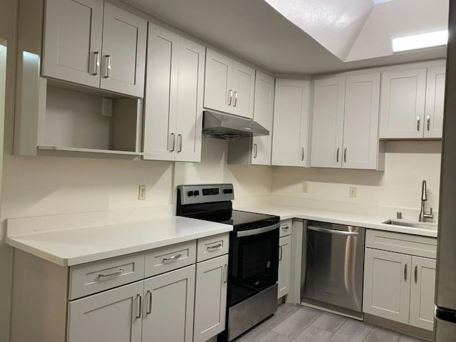 kitchen featuring stainless steel appliances, sink, and light wood-type flooring