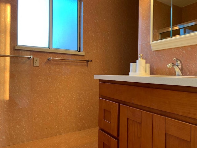 bathroom with vanity and a shower