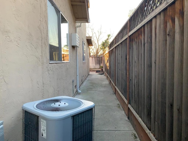 view of property exterior featuring a patio and cooling unit