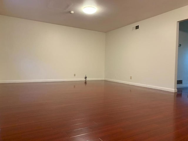 unfurnished room featuring dark wood-type flooring