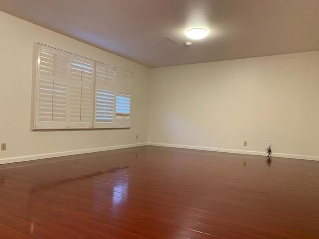 empty room with dark wood-type flooring