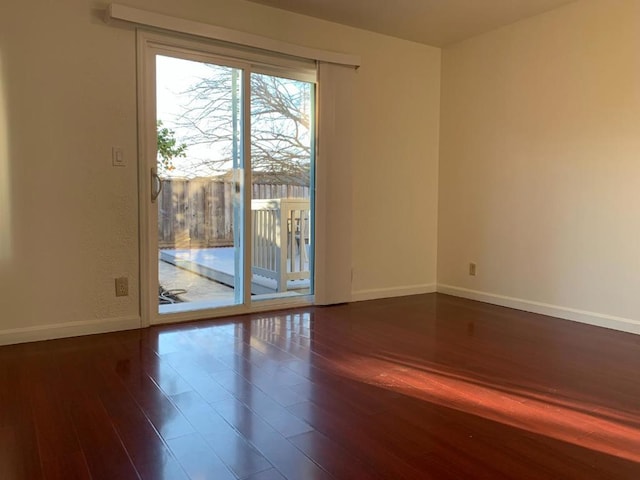 unfurnished room with hardwood / wood-style floors