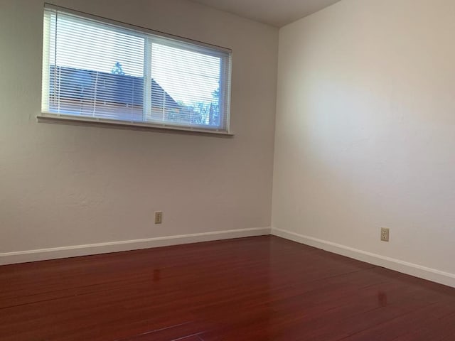 spare room featuring dark hardwood / wood-style floors