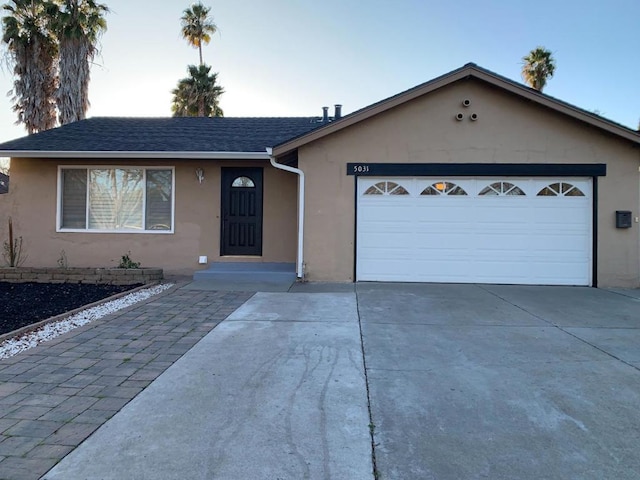 single story home featuring a garage