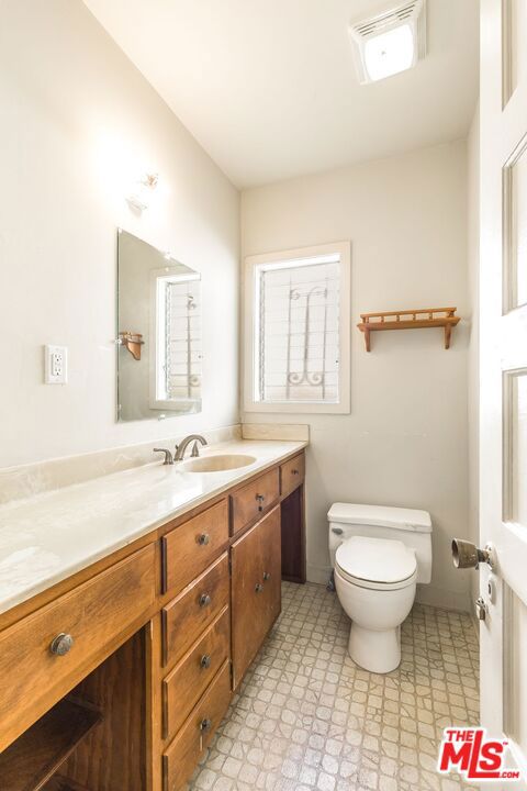 bathroom featuring vanity and toilet