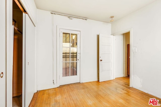 unfurnished bedroom with wood-type flooring and a closet