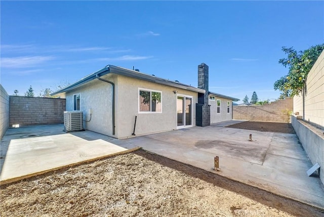 back of house featuring central AC and a patio area