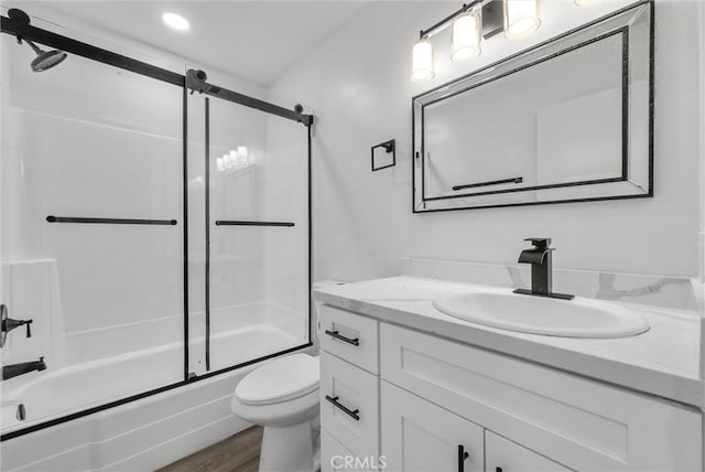 full bathroom featuring enclosed tub / shower combo, wood-type flooring, vanity, and toilet