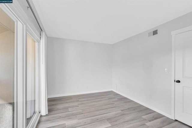 unfurnished room featuring light wood-type flooring