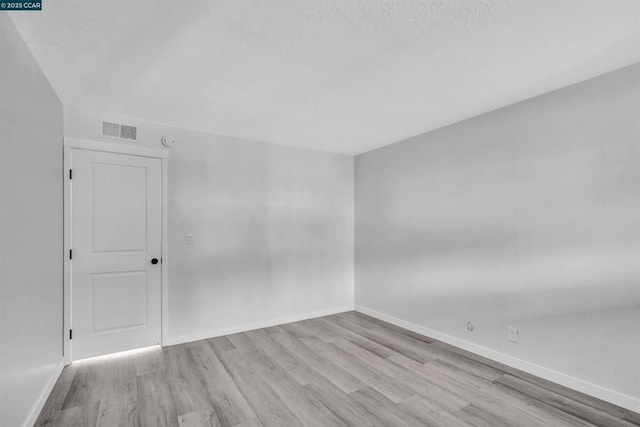 spare room featuring light hardwood / wood-style floors