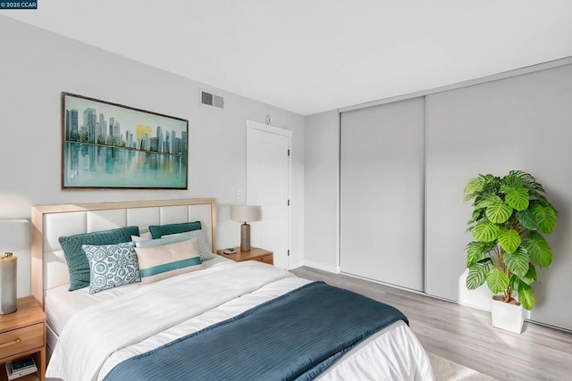 bedroom featuring hardwood / wood-style floors and a closet