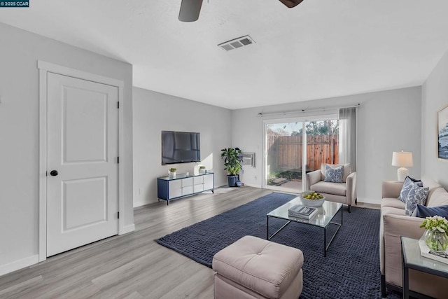 living room with ceiling fan and light hardwood / wood-style flooring