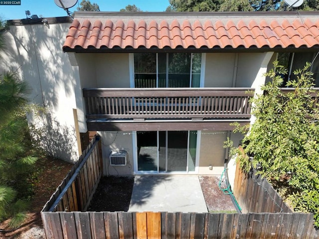 back of property featuring a patio and a balcony