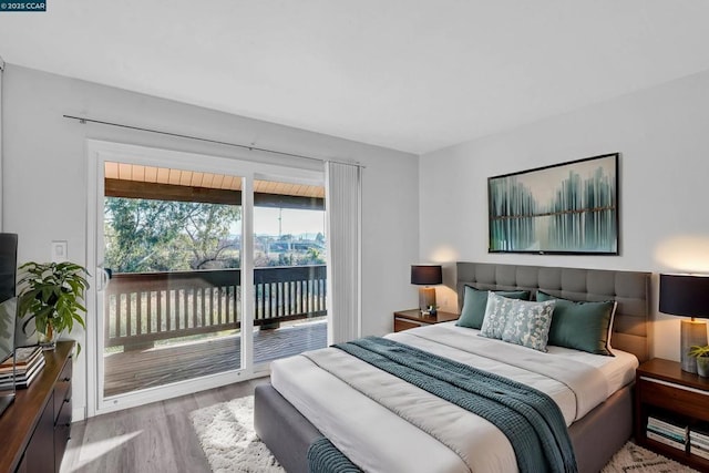 bedroom featuring light hardwood / wood-style flooring and access to outside