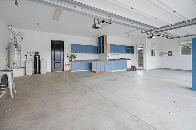 garage with a garage door opener and strapped water heater