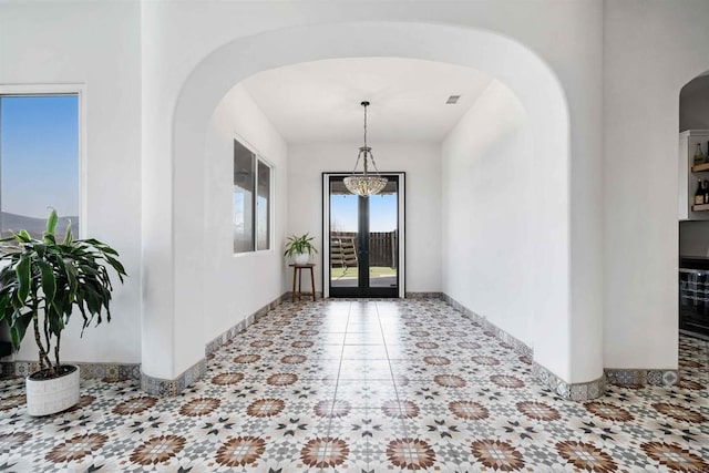 foyer entrance featuring a chandelier