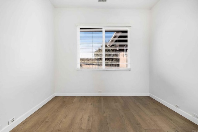 spare room with hardwood / wood-style floors