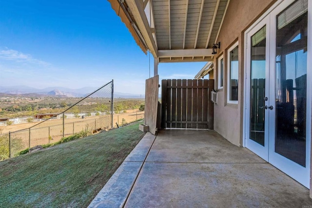 view of patio featuring a mountain view and french doors