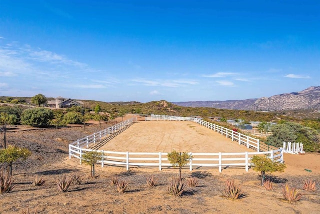 view of yard with a mountain view and a rural view