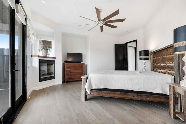 bedroom featuring hardwood / wood-style flooring and ceiling fan