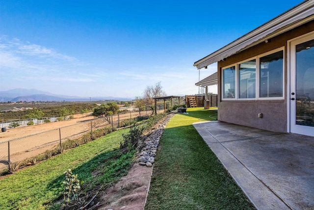 view of yard with a mountain view and a patio area