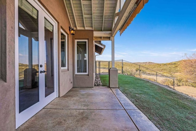 view of patio with a mountain view and french doors