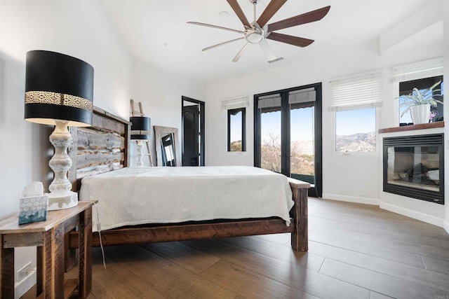 bedroom featuring french doors, ceiling fan, wood-type flooring, and access to outside