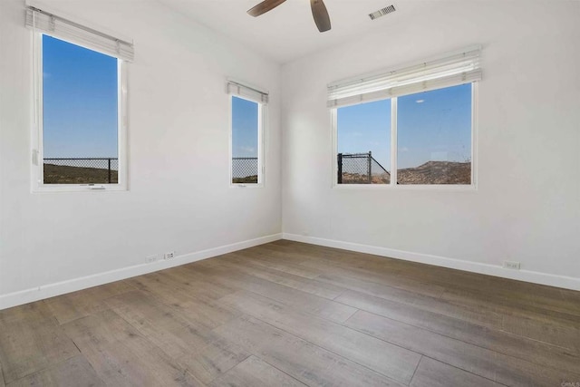 spare room featuring hardwood / wood-style flooring and ceiling fan