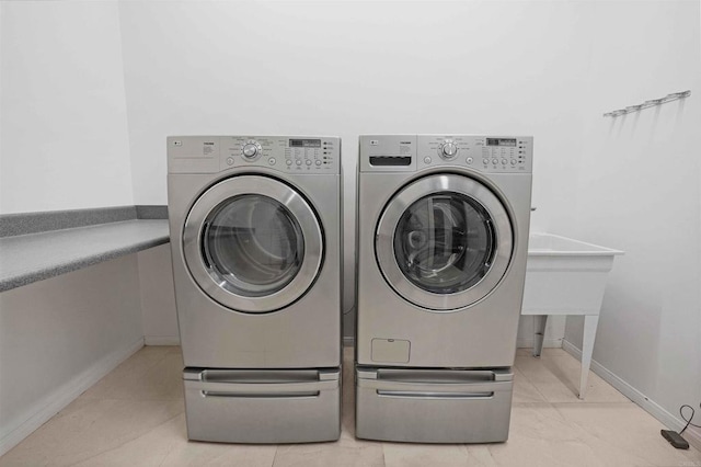 clothes washing area featuring washer and clothes dryer