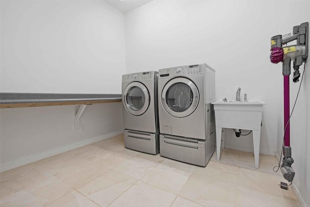 washroom featuring washing machine and dryer and light tile patterned floors