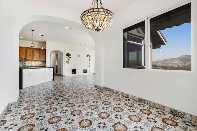 24916 Bareta Star Ranch Rd, Ramona, CA 92065 - spare room featuring arched walkways, baseboards, and recessed lighting