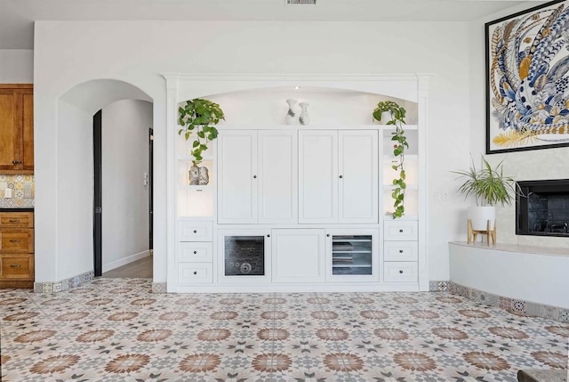 24916 Bareta Star Ranch Rd, Ramona, CA 92065 - unfurnished living room with arched walkways and a high end fireplace
