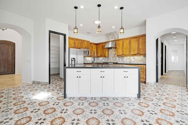 24916 Bareta Star Ranch Rd, Ramona, CA 92065 - kitchen featuring arched walkways, stainless steel appliances, wall chimney exhaust hood, decorative backsplash, and recessed lighting
