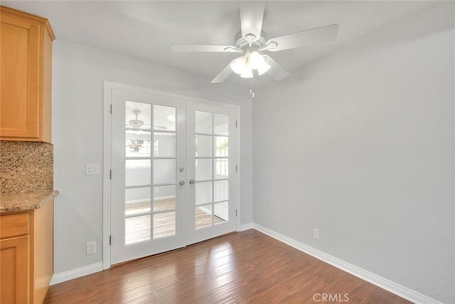 interior space with wood finished floors, french doors, baseboards, and ceiling fan