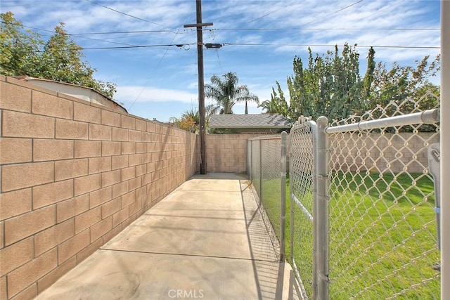 exterior space featuring a fenced backyard and a gate