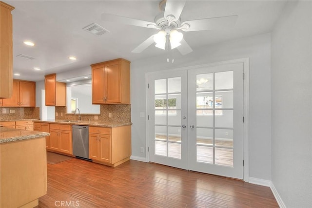 kitchen featuring light wood finished floors, visible vents, decorative backsplash, french doors, and stainless steel dishwasher