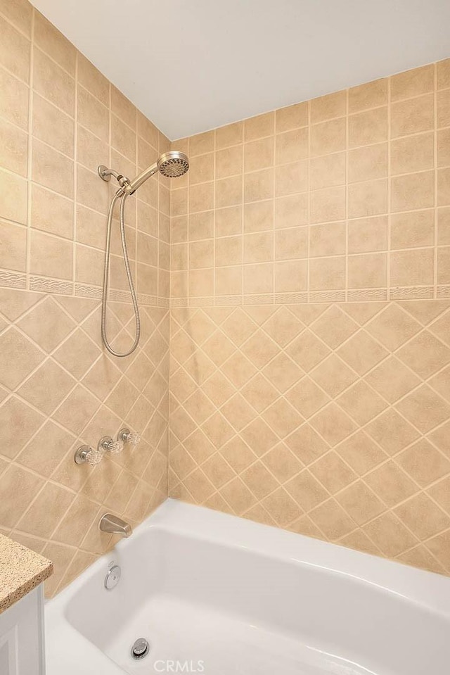 bathroom with vanity and  shower combination