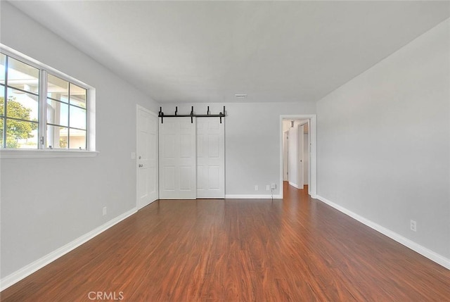 interior space featuring a closet, baseboards, and wood finished floors