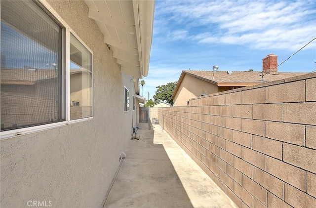 view of property exterior featuring fence and stucco siding