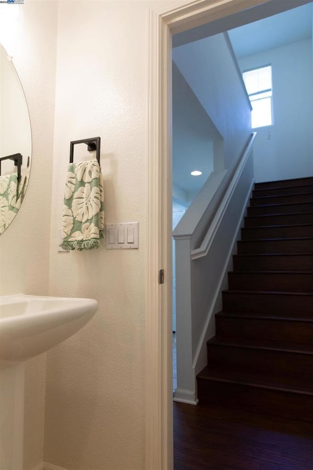 staircase with hardwood / wood-style floors