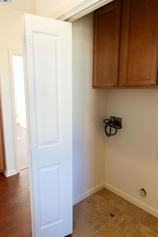 clothes washing area featuring cabinets